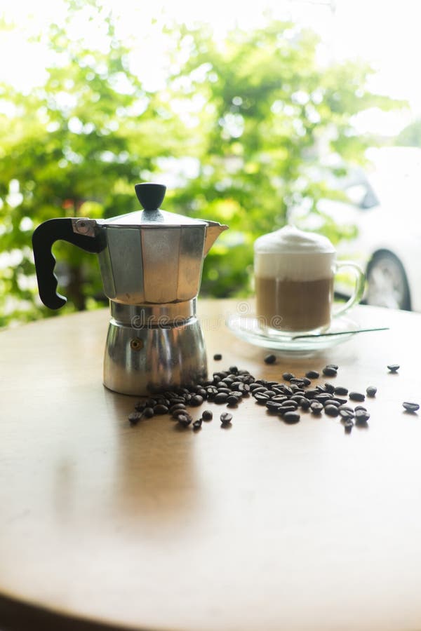 A Moka Pot and a Cup of Coffee with Roasted Coffee Beans Stock Image