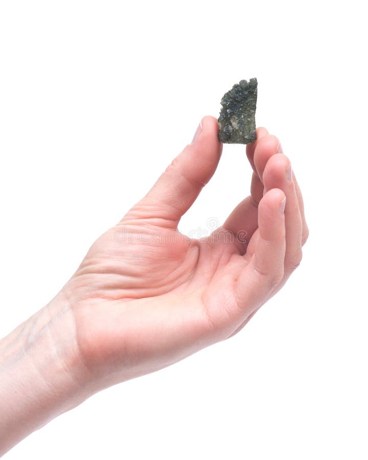 Young woman holding moldavite - form of tektite found along the banks of the river Moldau in Czech republic, isolated on white background. Young woman holding moldavite - form of tektite found along the banks of the river Moldau in Czech republic, isolated on white background