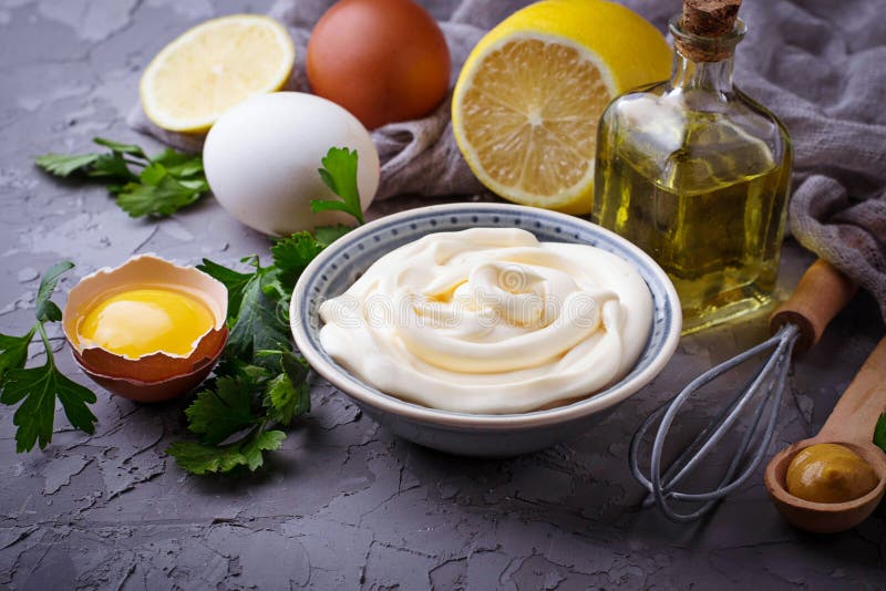 Homemade mayonnaise sauce and olive oil, eggs, mustard, lemon. Selective focus. Homemade mayonnaise sauce and olive oil, eggs, mustard, lemon. Selective focus