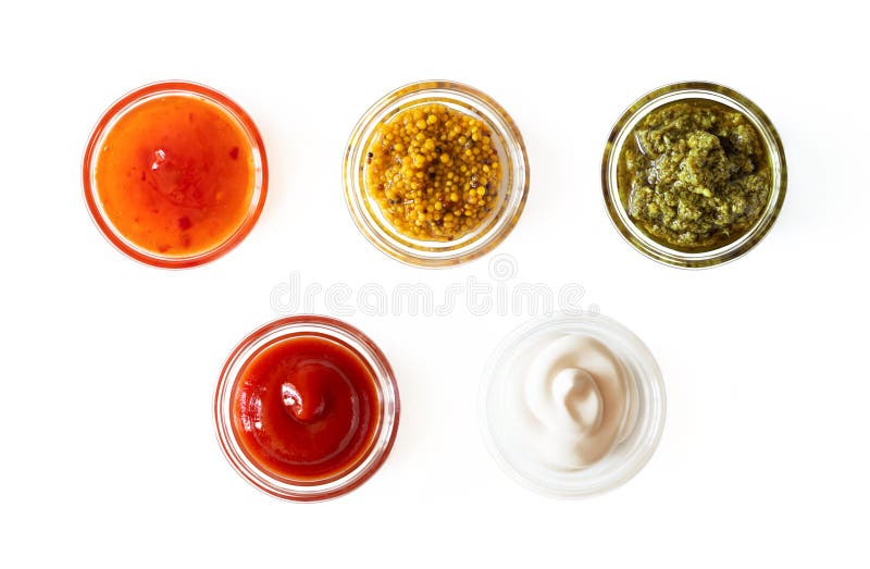 Sweet chili sauce, french mustard, basil pesto, ketchup and mayonnaise in glass bowls isolated on white background, top view. Various seasoning and dip border. Sweet chili sauce, french mustard, basil pesto, ketchup and mayonnaise in glass bowls isolated on white background, top view. Various seasoning and dip border
