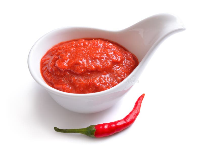 Red chili sauce in the sauce boat. With pepper. Isolated on white background. Red chili sauce in the sauce boat. With pepper. Isolated on white background.