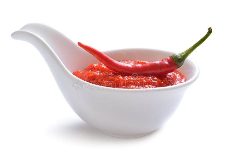 Red chili sauce in the sauce boat. With pepper. Isolated on white background. Red chili sauce in the sauce boat. With pepper. Isolated on white background.