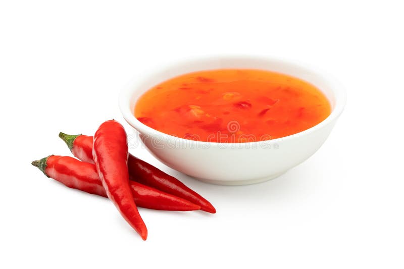 Sweet chilli sauce in a white ceramic bowl next to three red chillies isolated on white. Sweet chilli sauce in a white ceramic bowl next to three red chillies isolated on white.