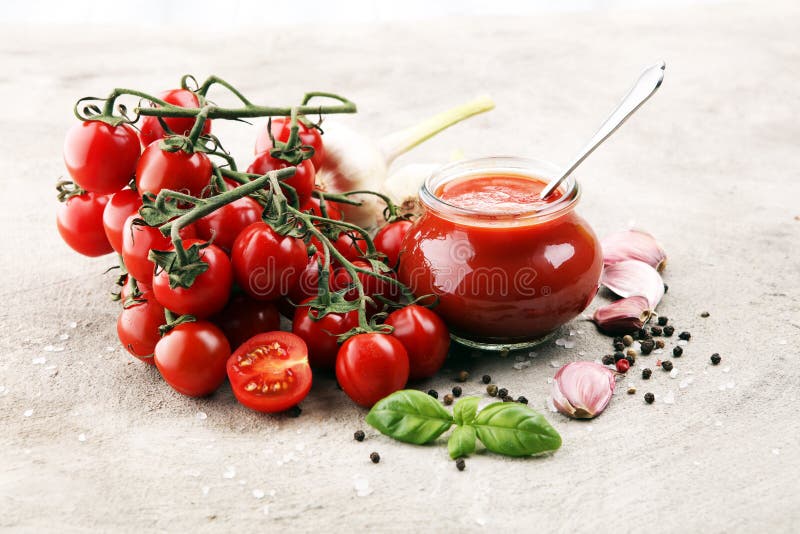 Fresh cherry tomato sauce on rustic background with cherry tomatoes. Fresh cherry tomato sauce on rustic background with cherry tomatoes
