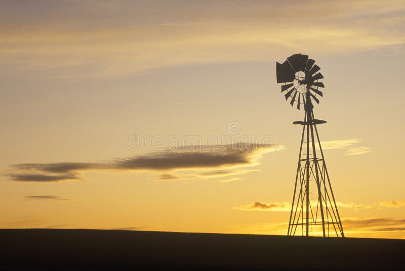 Silhouetted wooden windmill at sunset, South Dakota. Silhouetted wooden windmill at sunset, South Dakota