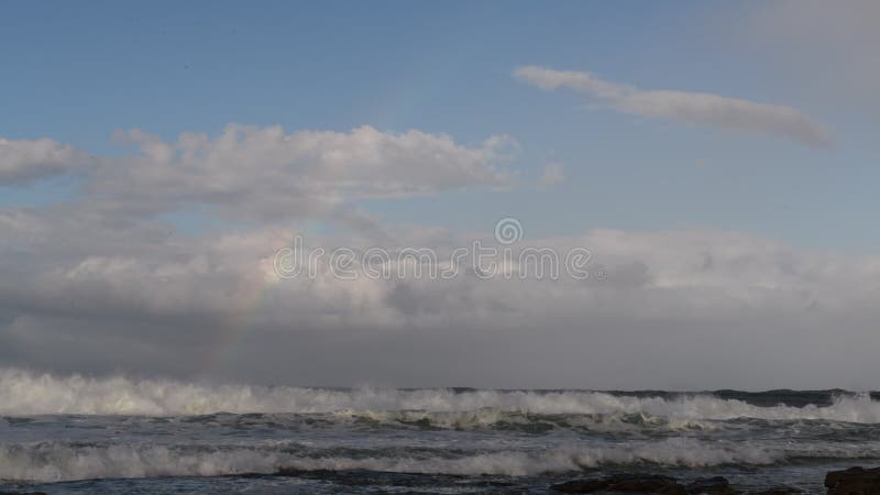 Moln och regnbåge i himlen över havet Sydafrika Mossel Bay