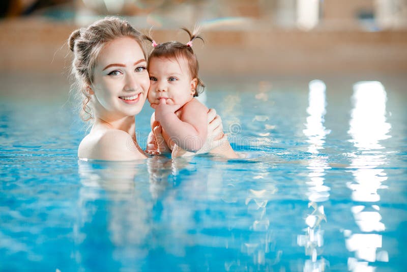 Mom and Baby Swim in the Pool. Stock Photo Image of care, development