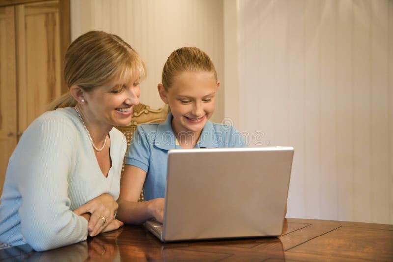 Mom and daughter with computer royalty free stock photo