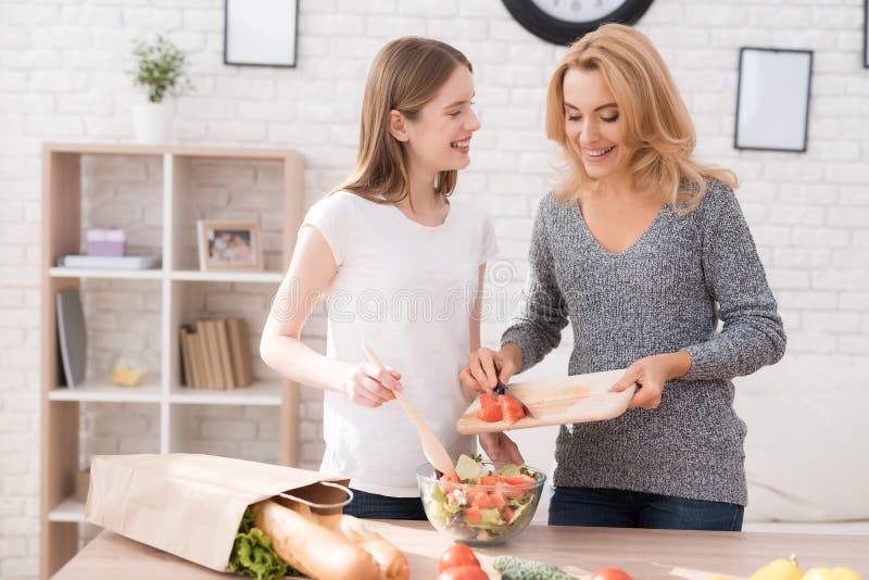 Mom And Daughter Are Cooking Together In The Kitchen Stock Image Image Of Cook Care 105710249