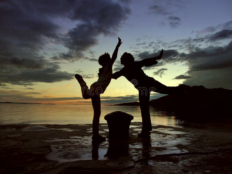 Dancers in sunset at sea