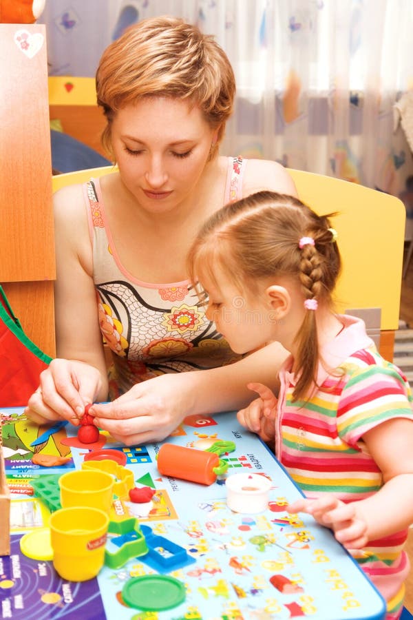 Mom and daughter playing stock photo. Image of motive - 4953936