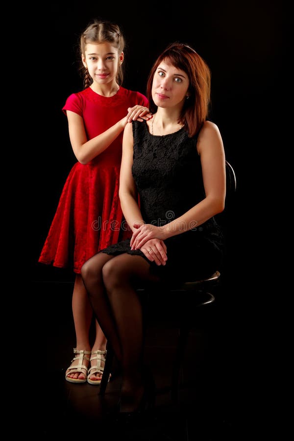 Mom and Daughter in the Studio on a Black Background. Stock Image ...
