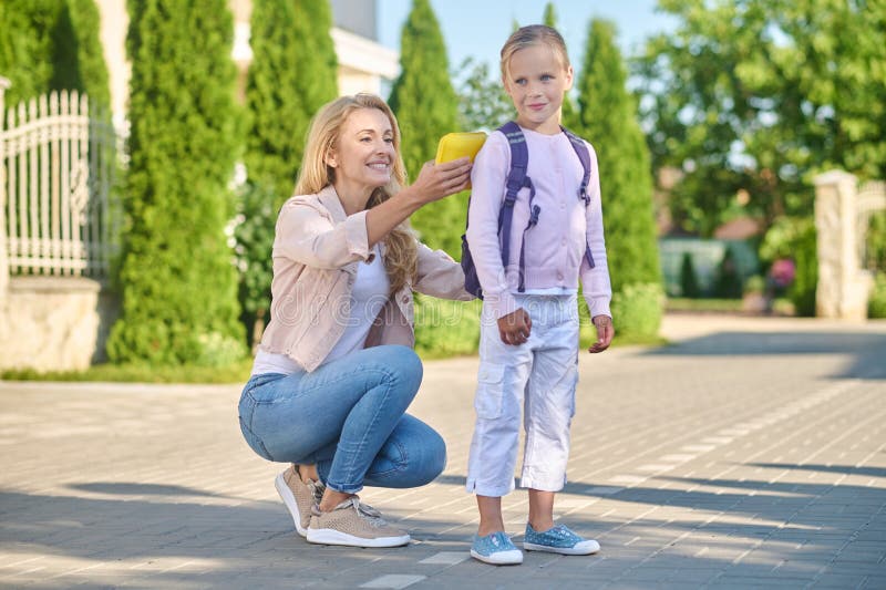 Mom Fixing a Backpack on Her Kids Back Stock Image Image of backpack