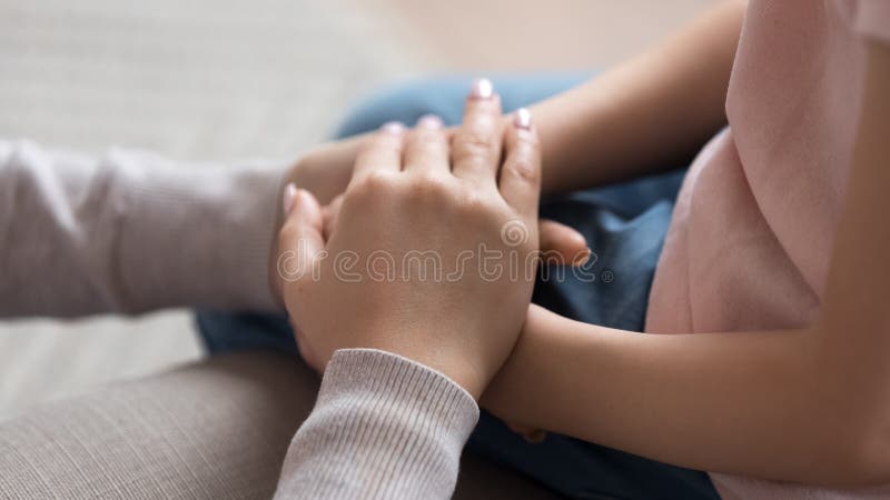 Mom giving support trust to little daughter holding hands, closeup royalty free stock photos Mom giving support trust to little daughter holding hands, closeup royalty free stock photos
