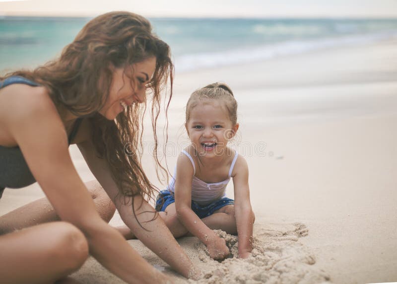 Mom and baby playing near beach. Traveling with family, child