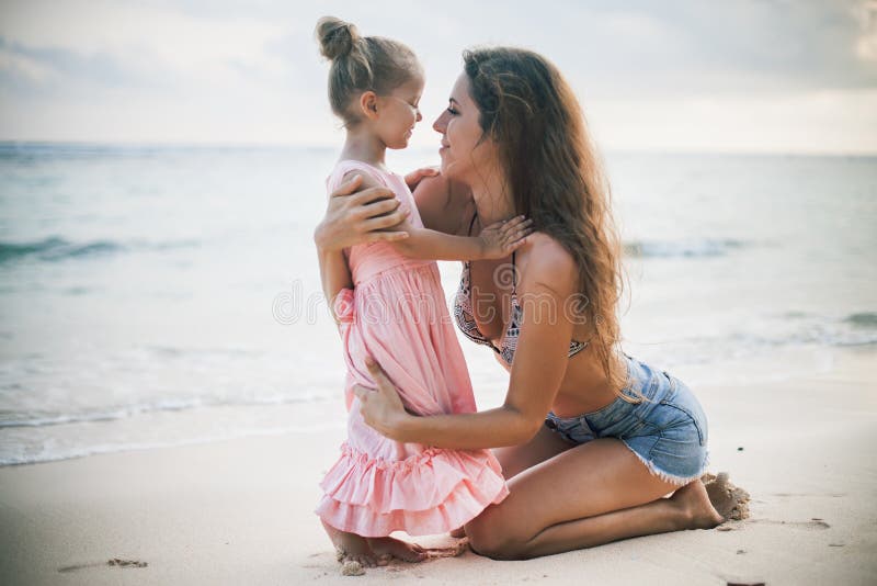 Mom and baby playing near beach. Traveling with family, child