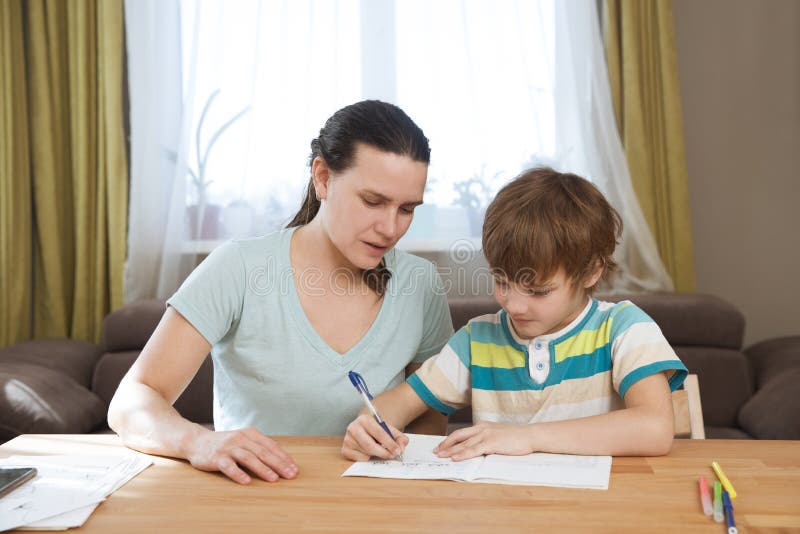 Mom Helps Son Mom Helps Child Boy Do Lessons at Home. Stock Photo - Image of infection, medical: 185354488