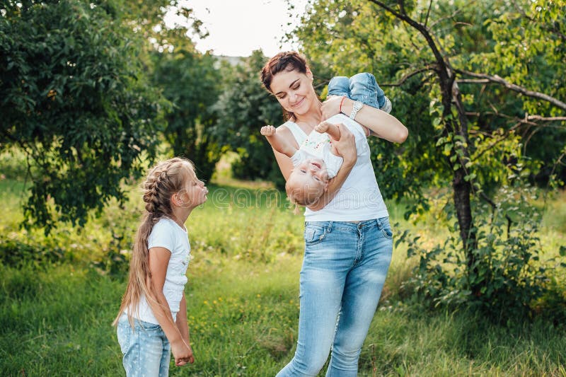 Mom And Her Daughters Are Walking In The Summer Park Stock Image 