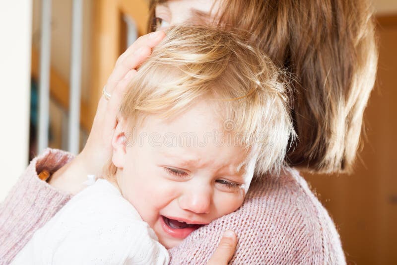 Mom holding crying child royalty free stock photo Mom holding crying child royalty free stock photo