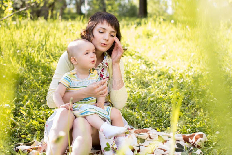 Mom and kid outdoors at summer stock images Mom and kid outdoors at summer stock images