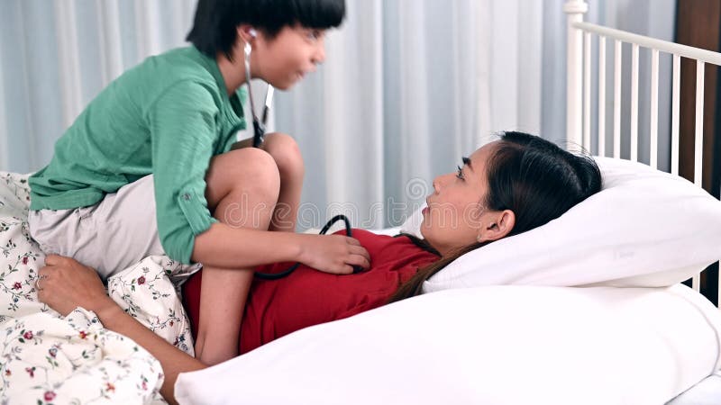 Mom and Kid Playing As Doctor Together on the Bed. Woman Lifestyle and Family Activity. Asian Mother at Home with Son Stock Footage - Video of parent, house: 190959374 
