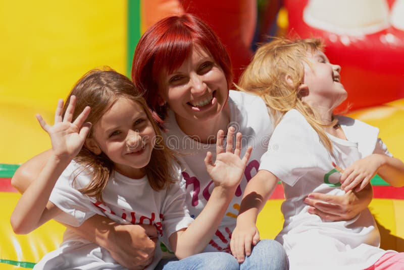 Mom and kids having fun on jumping castle