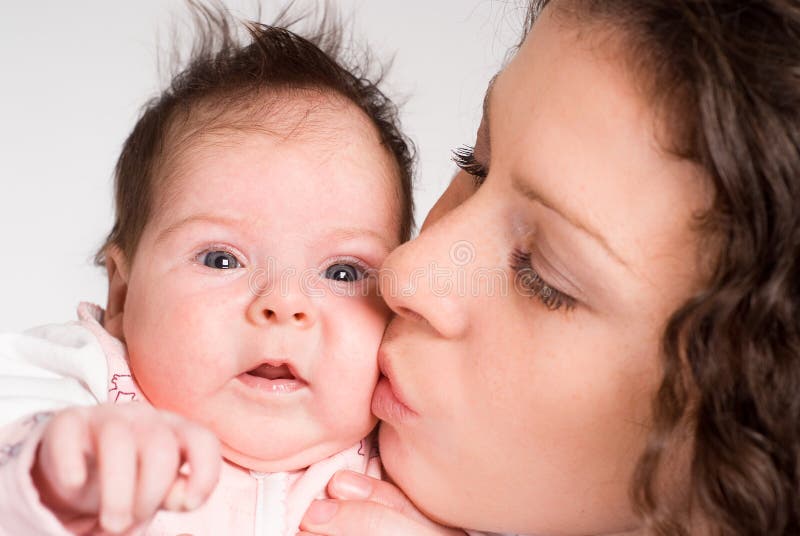 Mom kissing baby