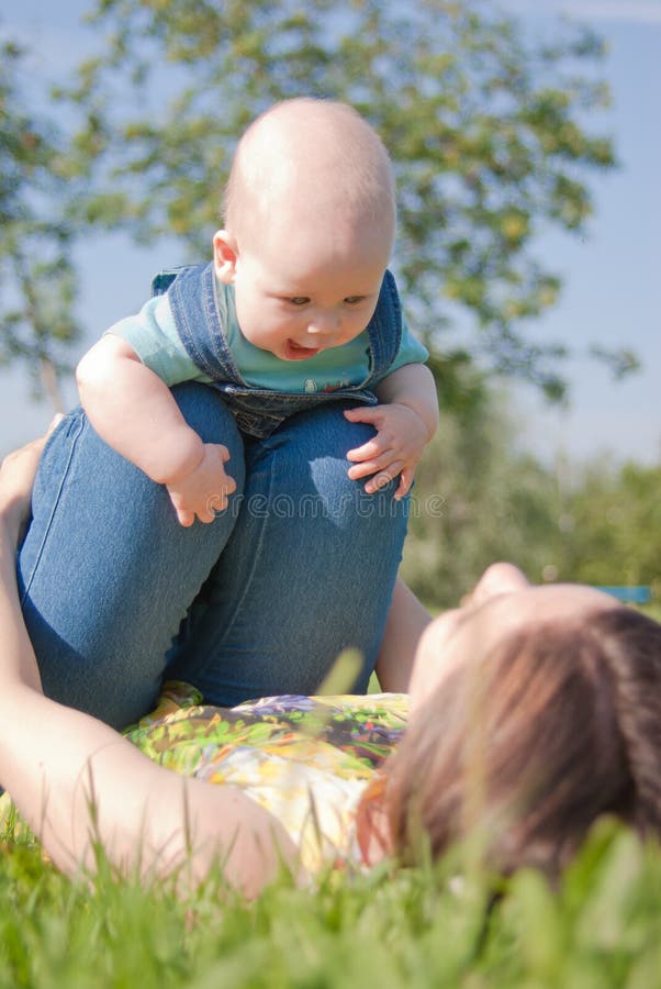 Mom Makes the Charge with Your Baby Stock Photo Image of high