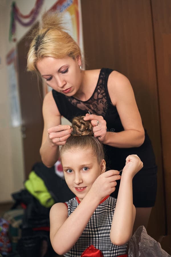 Mom Makes Daughter Hairstyle Preparing Her for the Performance. Stock Image  - Image of hairstylist, girl: 105440981