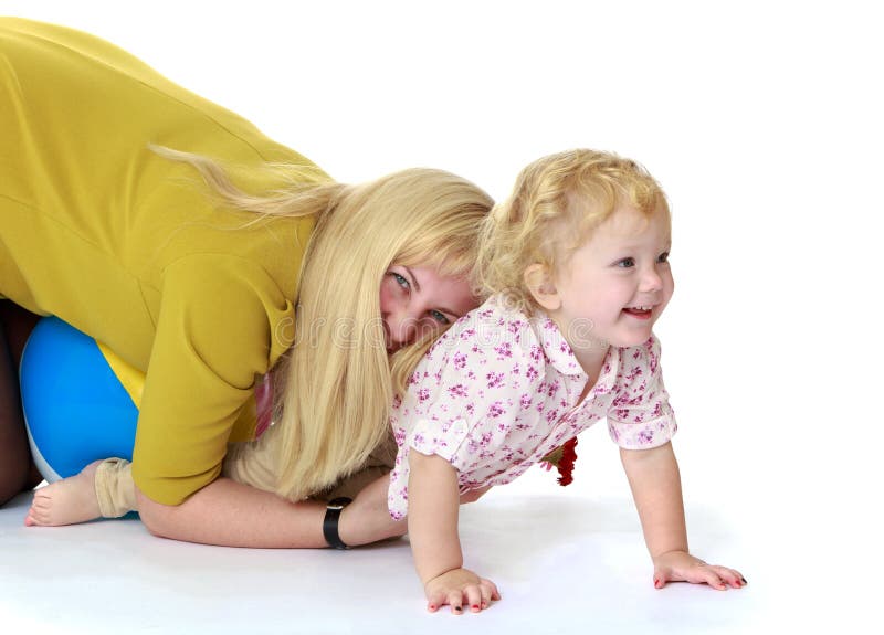 Mom plays on the floor with her little daughter