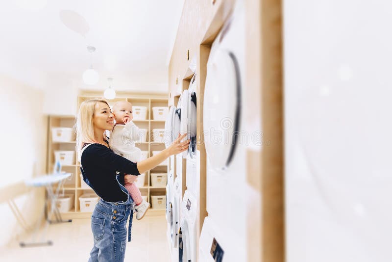 Mom Shows Her Daughter a Washing Machine Stock Photo Image of domestic, cute 111346016