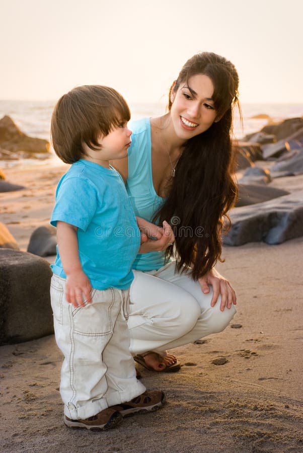 Mom and son on beach 1 stock image. Image of water, sand - 5022185