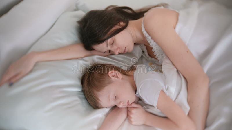 Mom and Son Sleeping Together. Mom Hugging Her Son. Stock Video - Video
