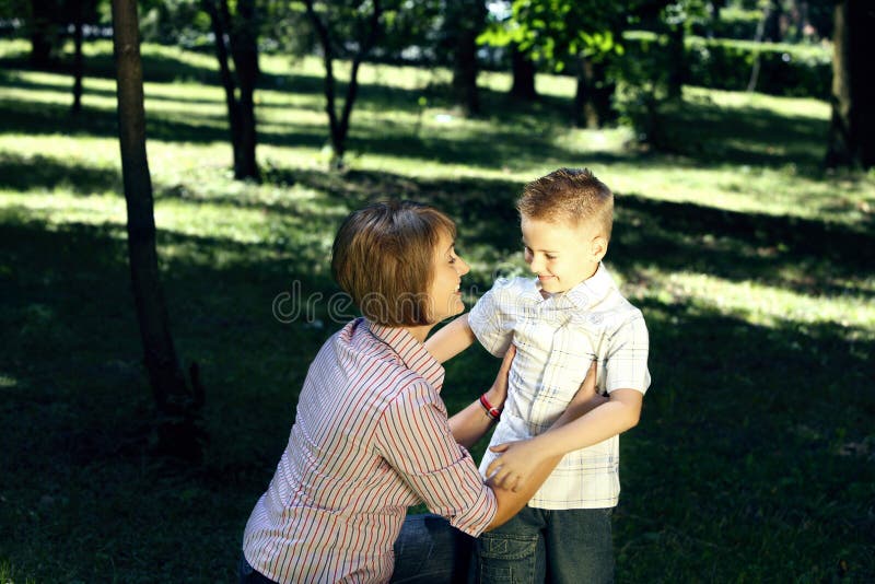 Mom and sun hugging outdoors