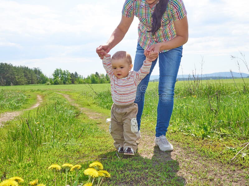 Mom teaches walks young son. stock image Mom teaches walks young son. stock image