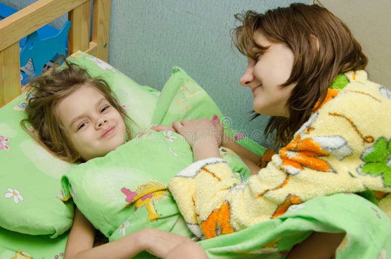 Mom Wakes Up Her Daughter In The Morning Stock Photo Image Of Lies