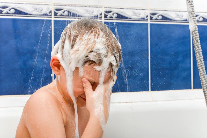 Mom Washes Shampoo from the Head of a Child Whose Eyes are Closed Stock