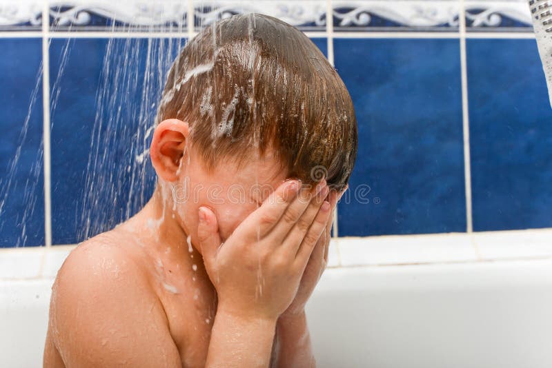 Mom Washes Shampoo from the Head of a Child Whose Eyes are Closed Stock