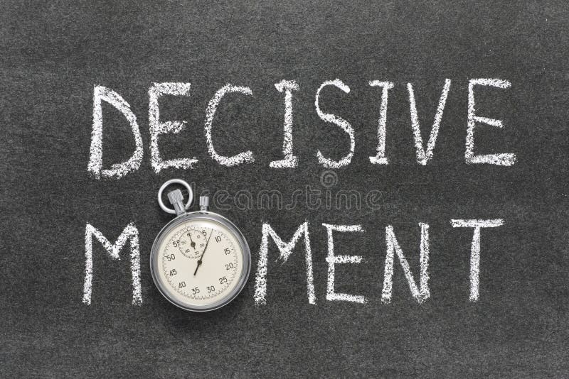 Decisive moment phrase handwritten on chalkboard with vintage precise stopwatch used instead of O. Decisive moment phrase handwritten on chalkboard with vintage precise stopwatch used instead of O