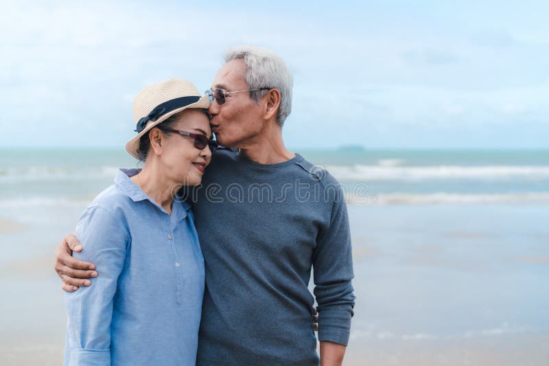 Kissing moment of asian couple senior elder retirement resting at beach honeymoon family together happiness people lifestyle, copy space the right. Kissing moment of asian couple senior elder retirement resting at beach honeymoon family together happiness people lifestyle, copy space the right