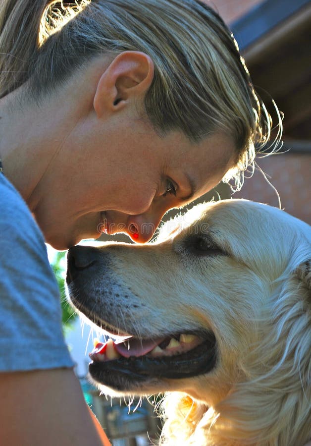 Magic moment between a blond girl and her white dog. Magic moment between a blond girl and her white dog