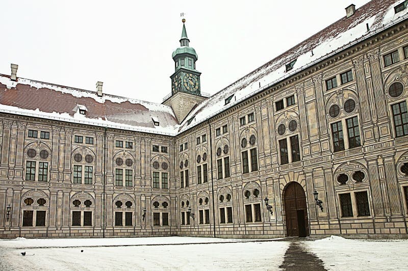 Munich, Germany - Suggestive winter view of one of the 10 courtyards of the Residenz, royal palace of the former Bavarian kings, in Renaissance Italian style with the facades painted with forced perspective decorations and the gothic clocktower. Munich, Germany - Suggestive winter view of one of the 10 courtyards of the Residenz, royal palace of the former Bavarian kings, in Renaissance Italian style with the facades painted with forced perspective decorations and the gothic clocktower