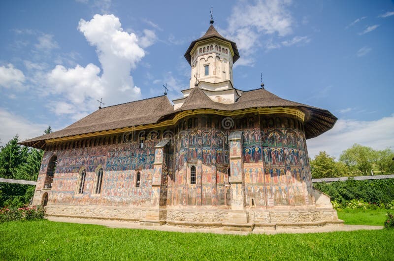 Humorului Monastery with a beautiful old historic painting on the walls in a traditional orthodox manner in Moldavia Region of Romania on a sunny summer day. Humorului Monastery with a beautiful old historic painting on the walls in a traditional orthodox manner in Moldavia Region of Romania on a sunny summer day.