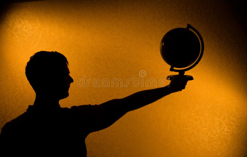 Monde dans des vos mains - silhouette de l'homme photographie stock Monde dans des vos mains - silhouette de l'homme photographie stock