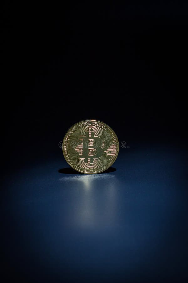 Moneta da bitone d'oro su fondo nero fotografie stock