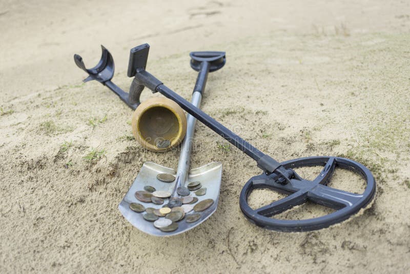 Search for treasure using a metal detector and shovel. Search for treasure using a metal detector and shovel.