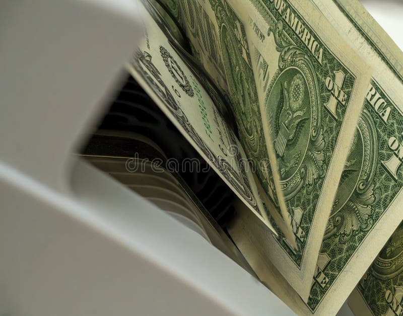 Money being processed in a currency counting machine at a bank stock images
