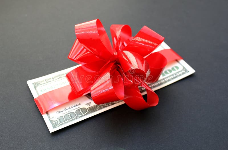 Money dollars wrapped in a bow on a gift