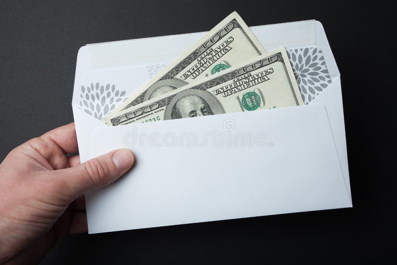 Money in an Envelope on a Black Background. 100 Dollar Bills Stock
