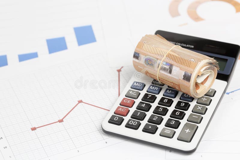 Money roll on calculator stock images
